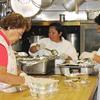 Kitchen staff preparing hot lunches for seniors