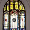 Each of our side windows has the same general pattern with floral and Gothic motifs, crests on each side, and a different glass feature in the center.  The following images will display each one separately.